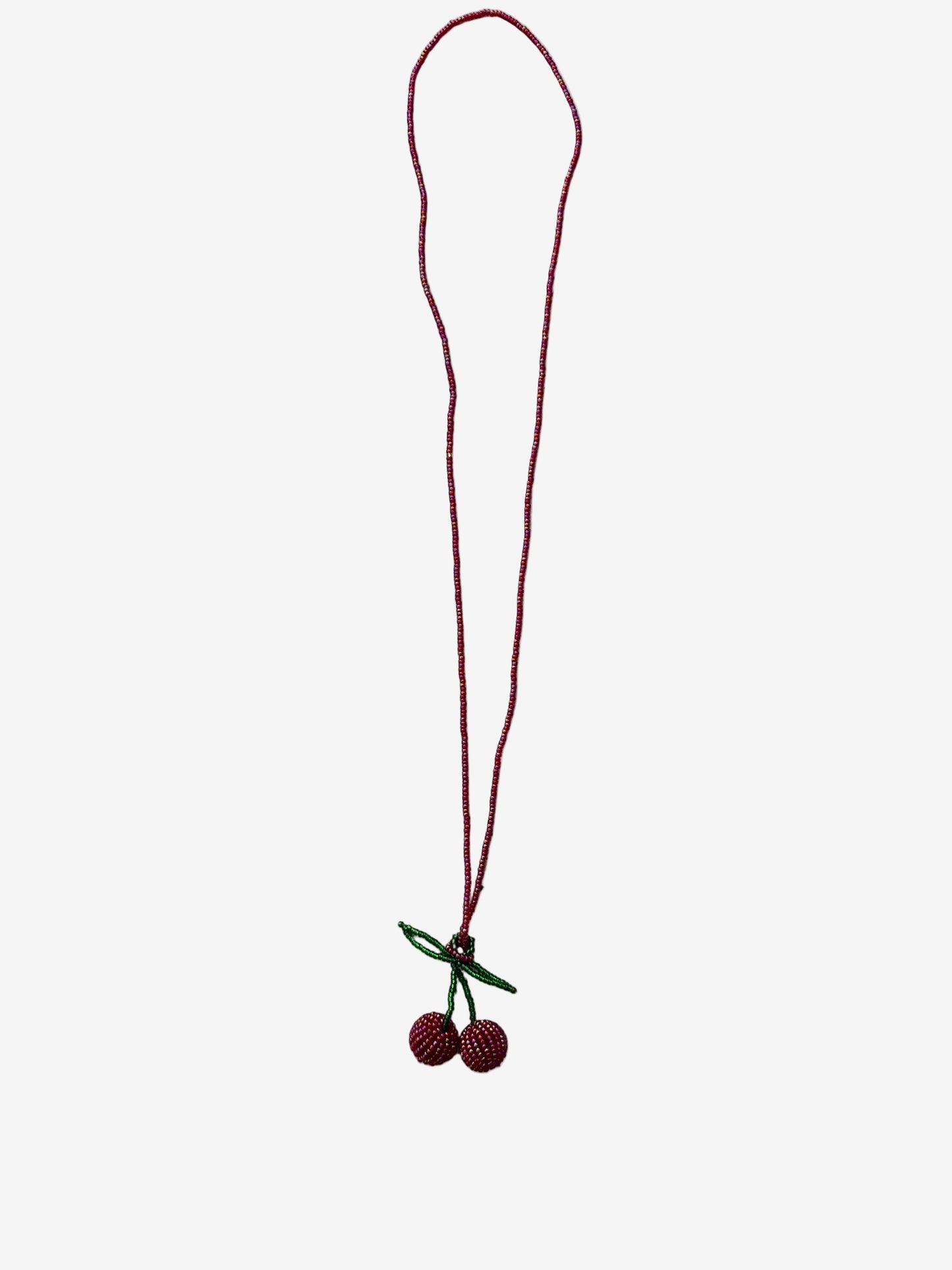 Gloss cherry necklace showing reflective red beads and detailed texture close up