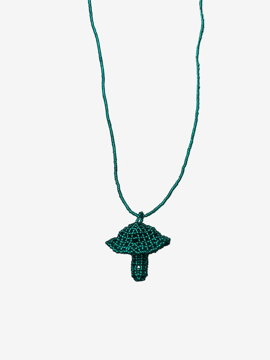 Emerald fungi necklace hanging on concrete background