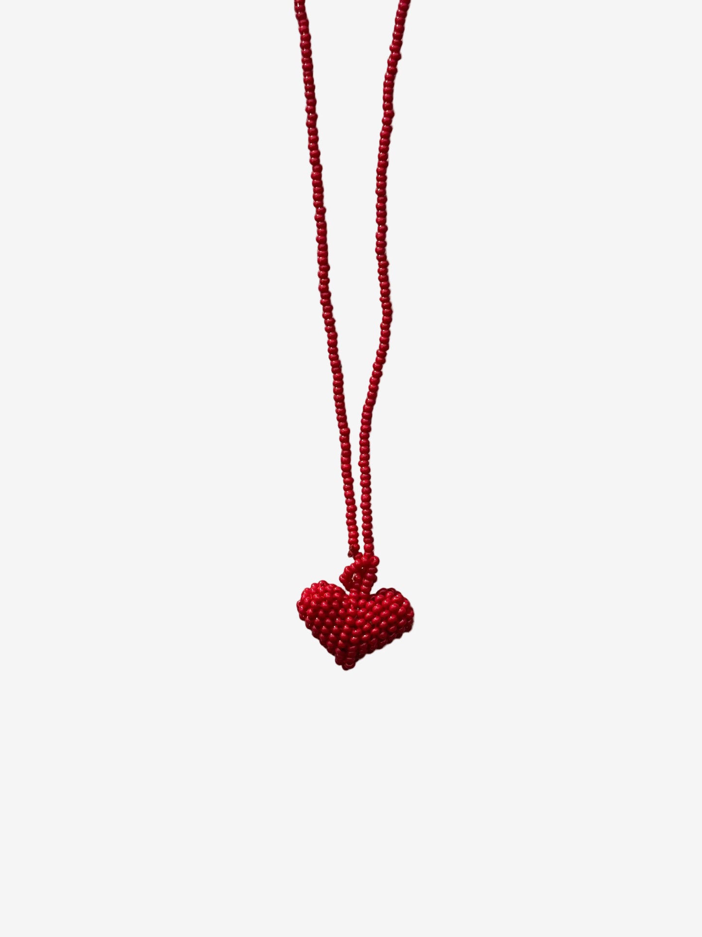 Red heart-shaped pendant on a string 