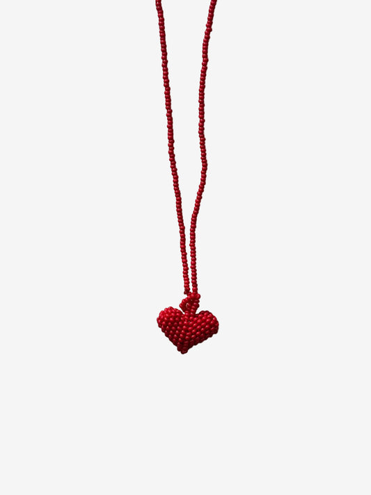 Red heart-shaped pendant on a string 