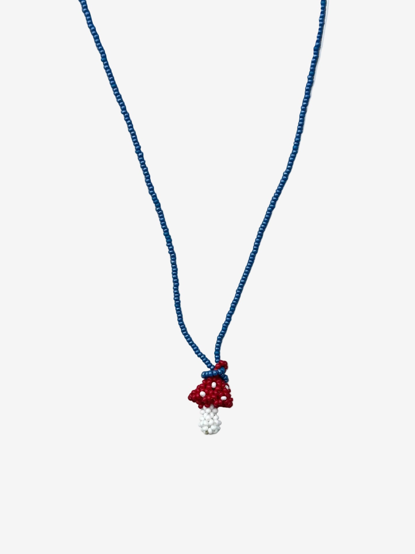 Small red and white fungi necklace with cobalt blue chain handmade by Guava