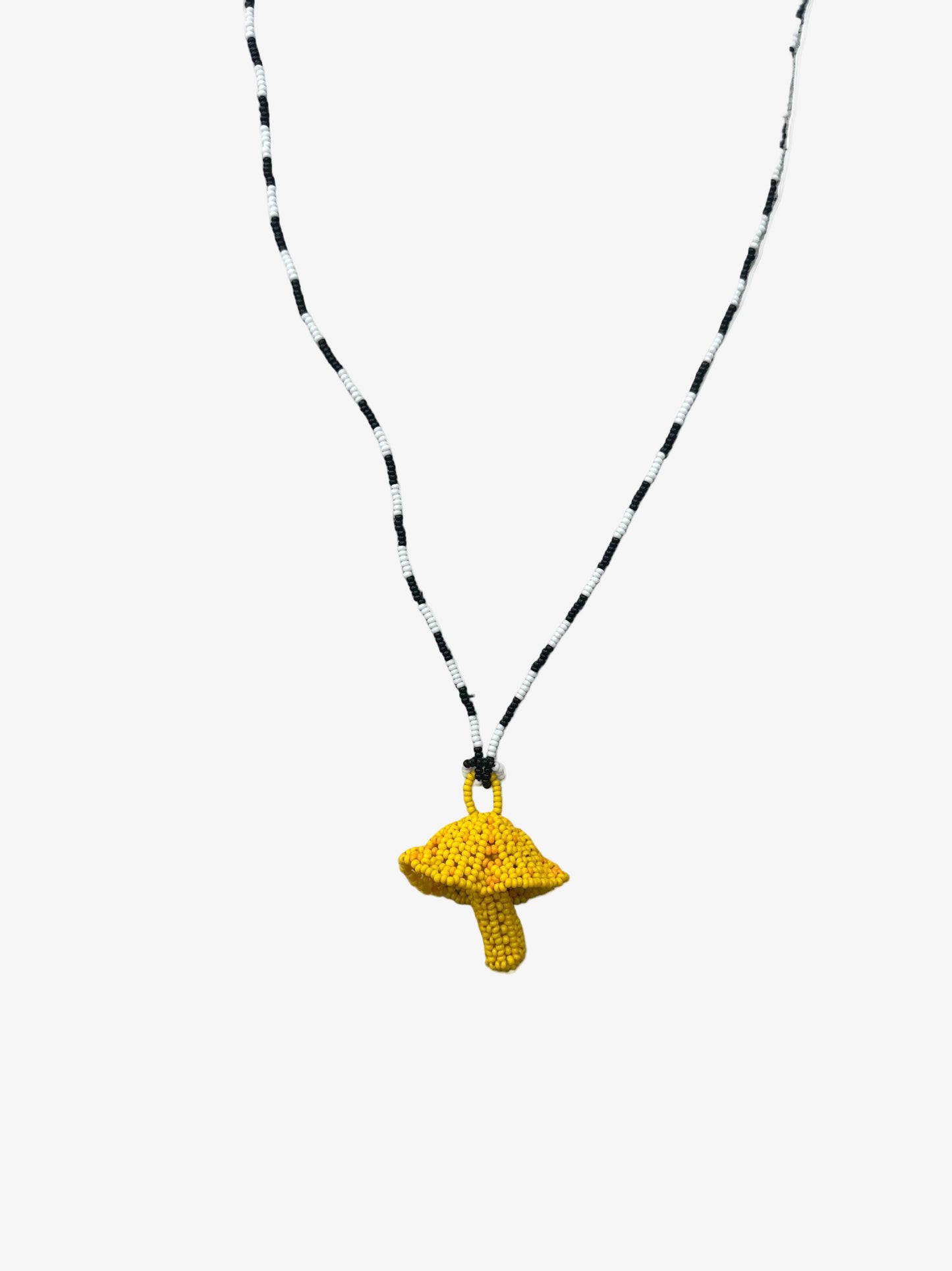 Yellow fungi necklace with black and white beaded chain handmade by Guava