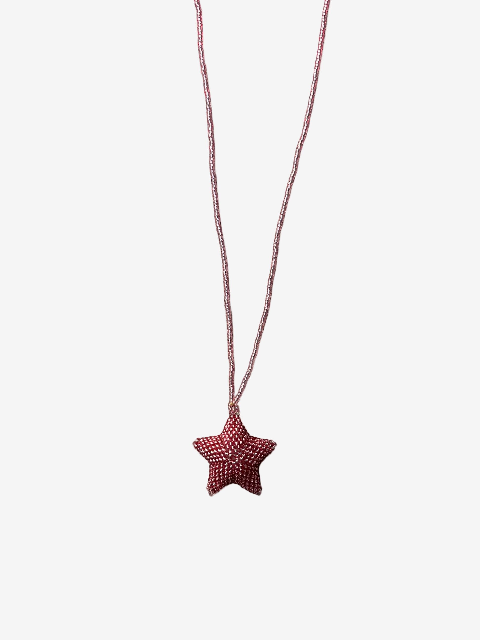 Star-shaped pink pendant on a string 